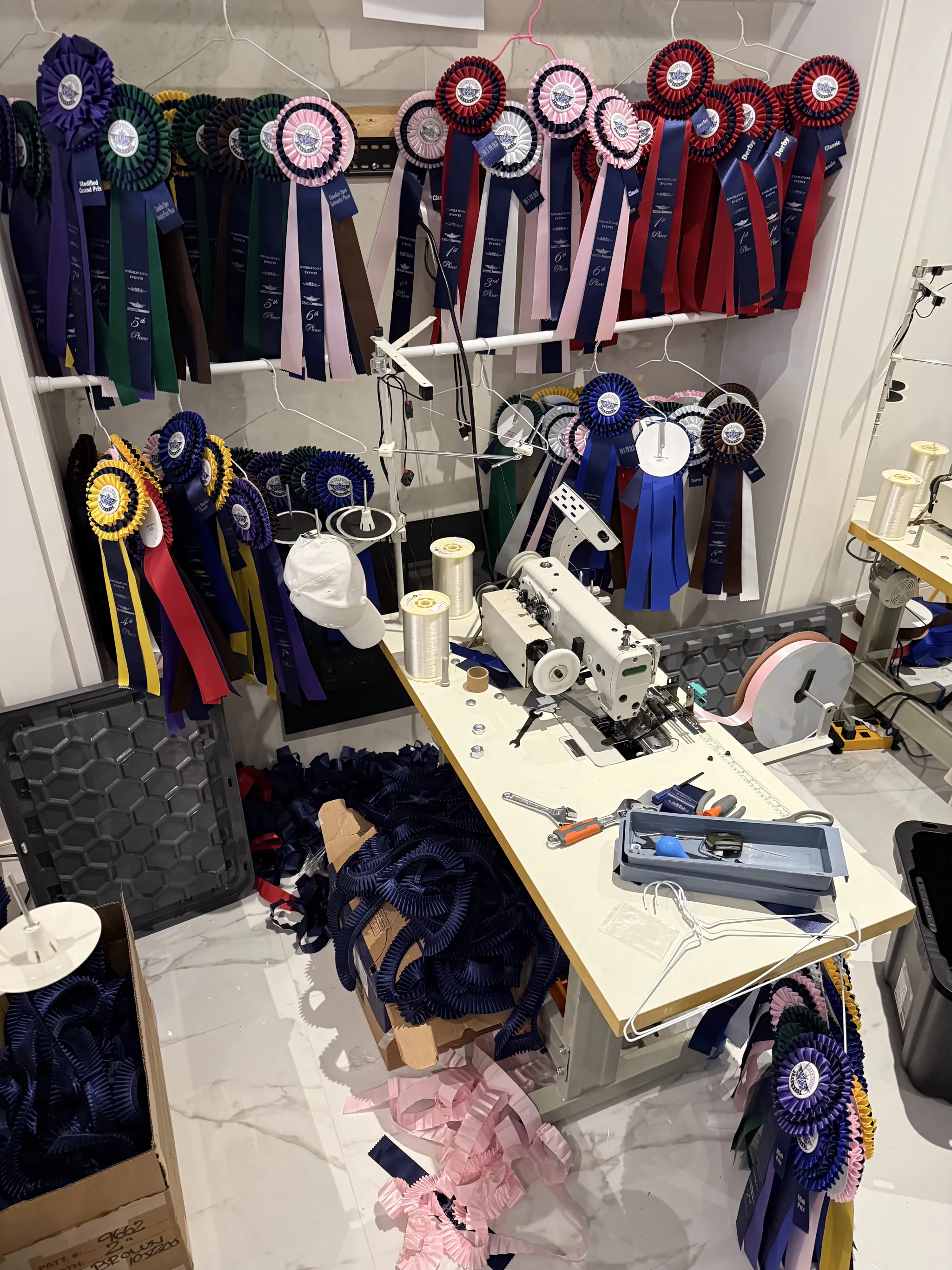 Custom award ribbons hanging in the Rosette Makers studio